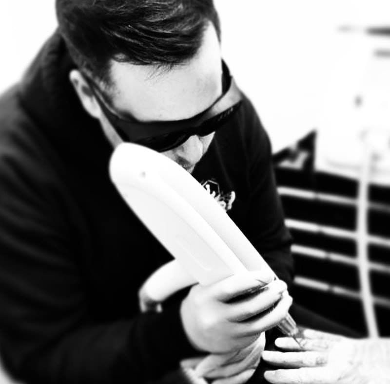 A man wearing sunglasses is holding something in his hands