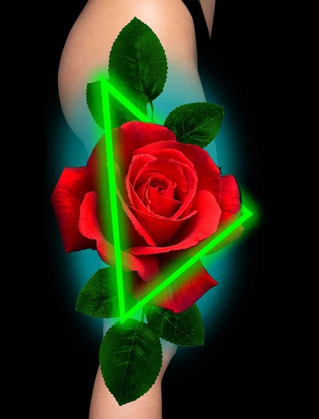 A woman has a tattoo of a red rose on her arm